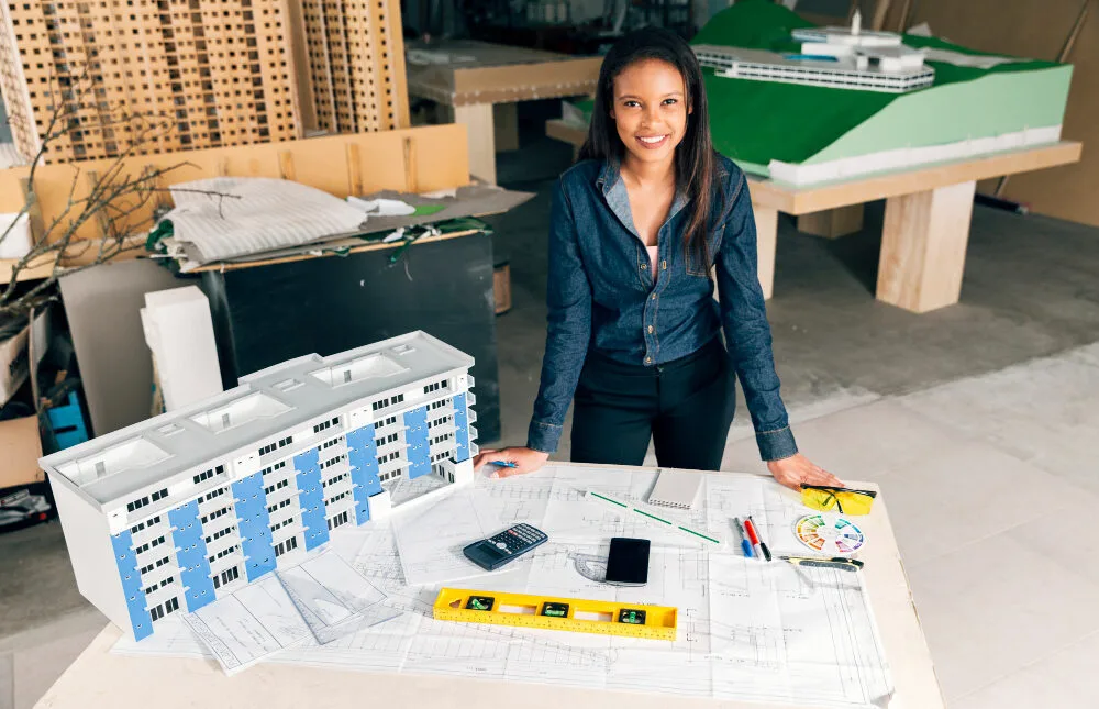 Architect reviewing Texas MUD financing options with model buildings and blueprints, considering MUD reimbursement financi...