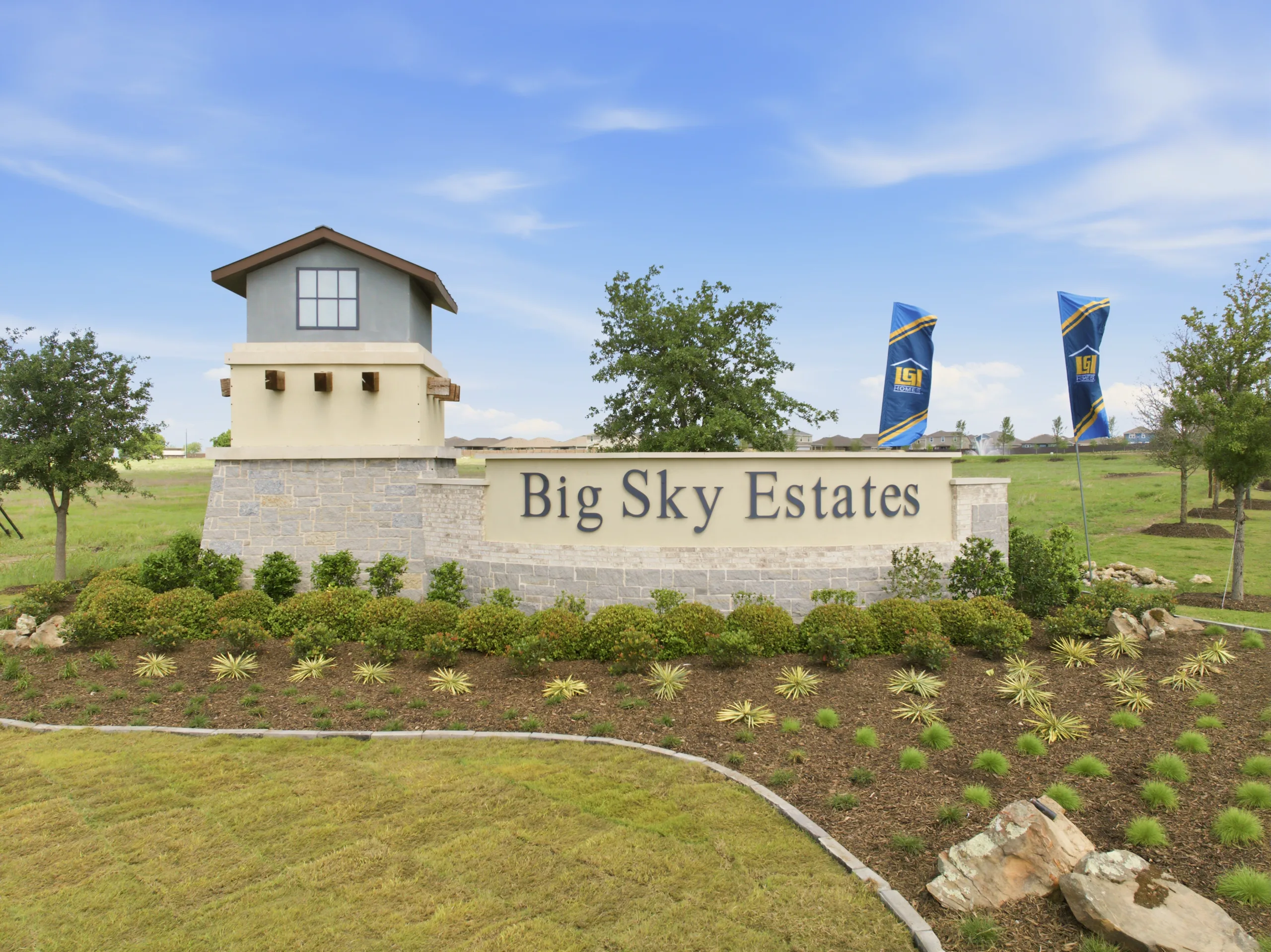 Big Sky Estates sign with flags, representing Texas MUD financing options and MUD district funding solutions with competit...