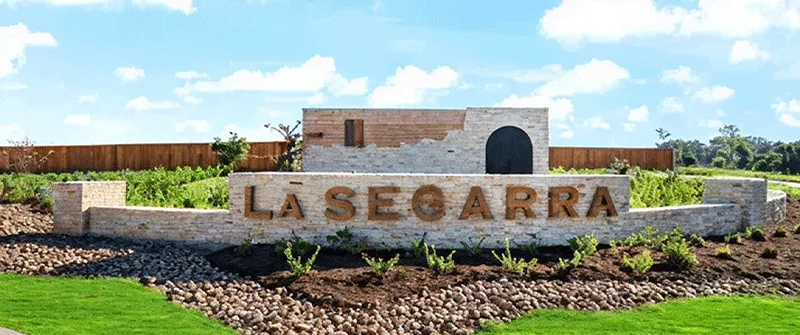 La Segarra Texas MUD financing sign with stone wall and green lawn, offering MUD district funding solutions and water dist...