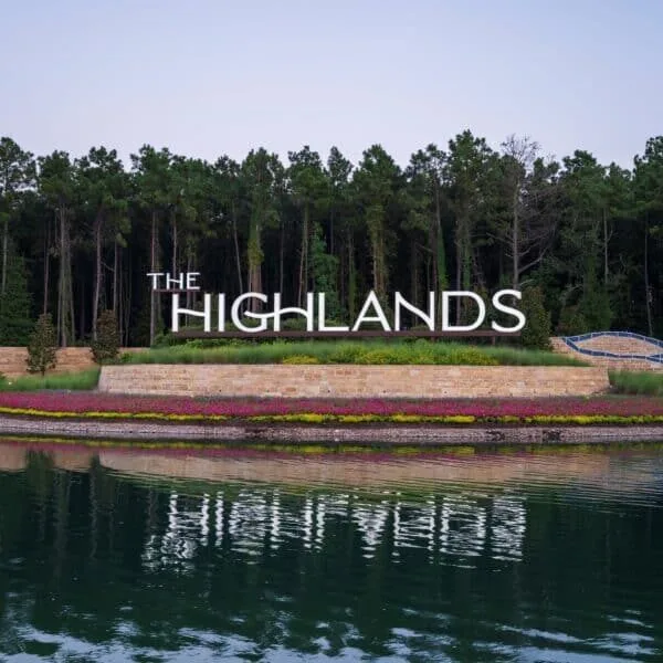 Serene lakefront scene with The Highlands sign, reflecting Texas MUD financing solutions and water district funding programs.