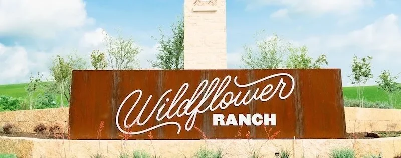 Wildflower Ranch sign with tower, representing Texas MUD financing options and MUD district funding solutions like reimbur...