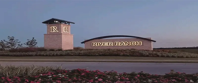 River Ranch entrance sign with lush landscaping, symbolizing growth and development, related to Texas MUD financing option...