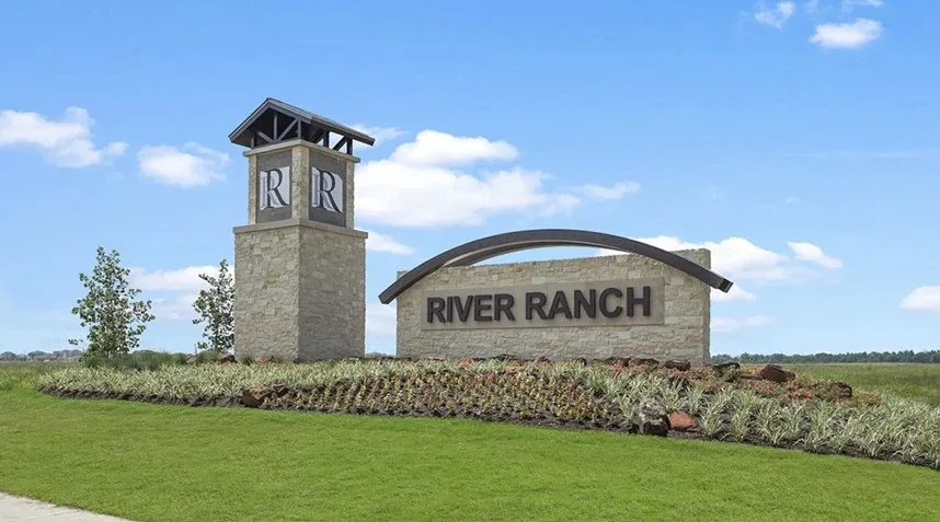 River Ranch entrance sign with lush greenery and blue sky, symbolizing growth and development, related to Texas MUD financ...