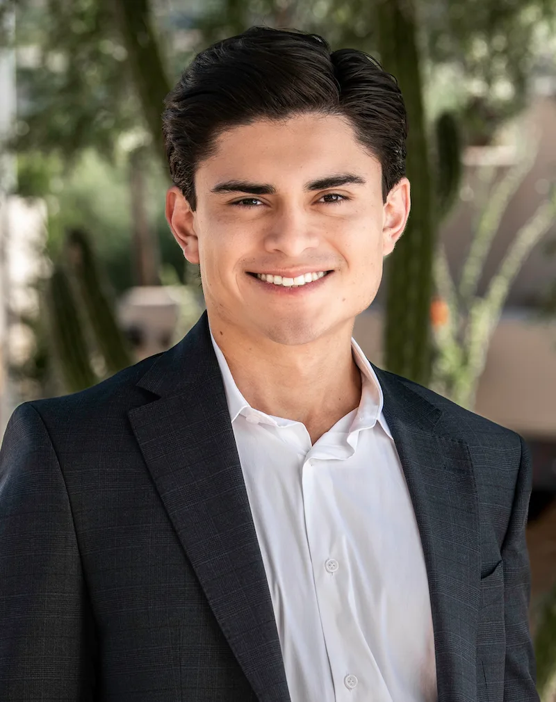 Young professional in a suit smiling, representing expertise in Texas MUD financing options and MUD district funding solut...