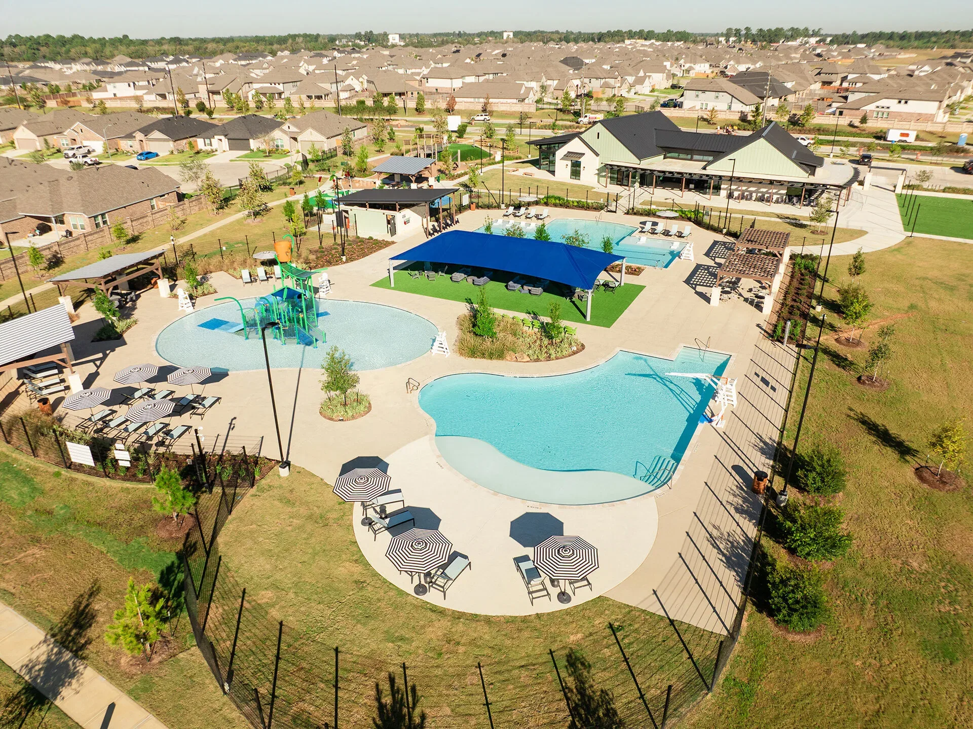 Aerial view of a modern community pool and recreational area in Texas, showcasing MUD district funding solutions and water...
