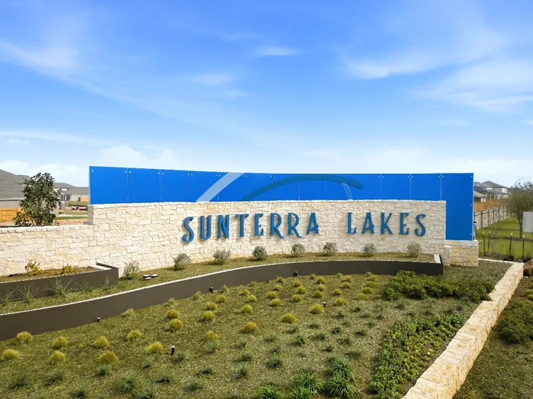 Sunterra Lakes entrance sign with blue and stone design, representing Texas MUD financing options and water district fundi...